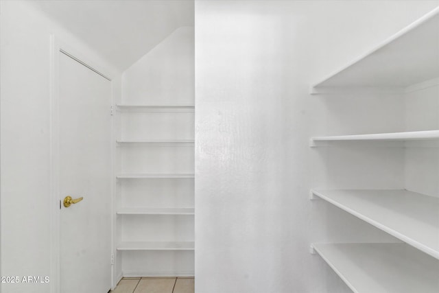 spacious closet with light tile patterned flooring