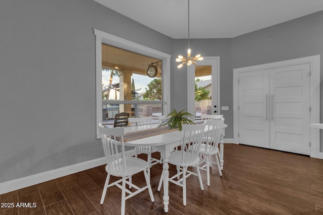 dining space featuring dark hardwood / wood-style floors and a notable chandelier