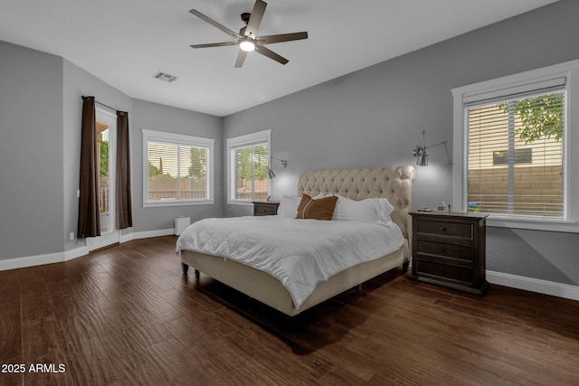 bedroom featuring multiple windows, dark hardwood / wood-style flooring, and ceiling fan