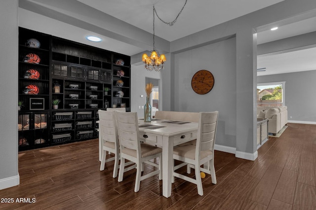 dining space with built in shelves and an inviting chandelier