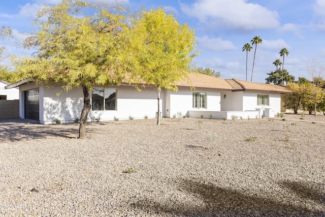 back of property with a garage