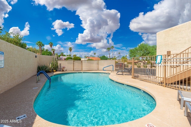 pool featuring a patio area and fence