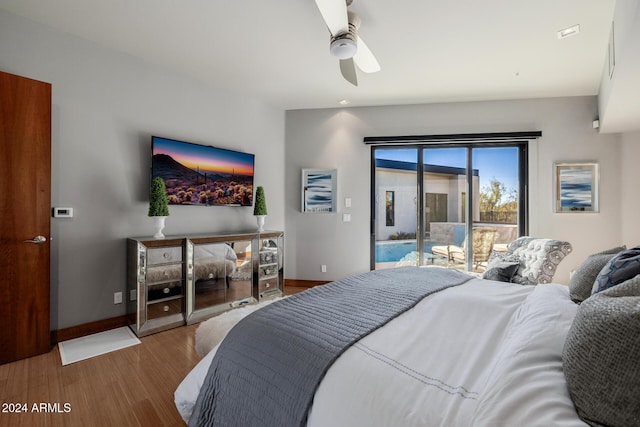 bedroom with hardwood / wood-style floors, ceiling fan, and access to outside