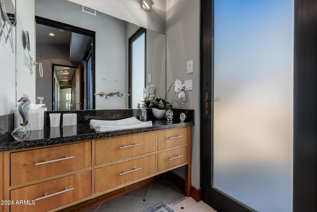 bathroom featuring tile patterned flooring and vanity