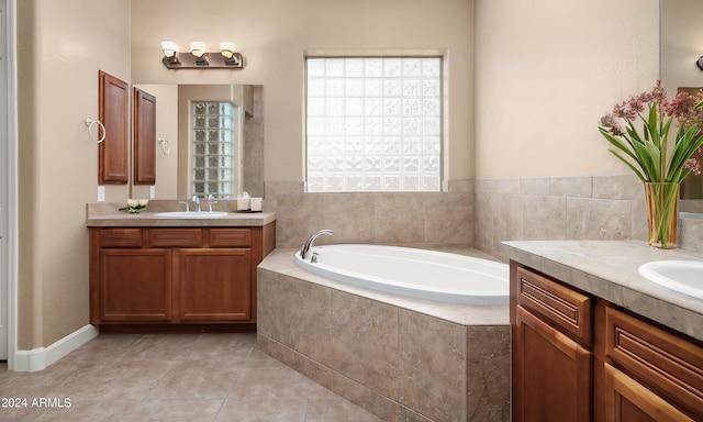 bathroom featuring vanity, tiled bath, and tile patterned floors