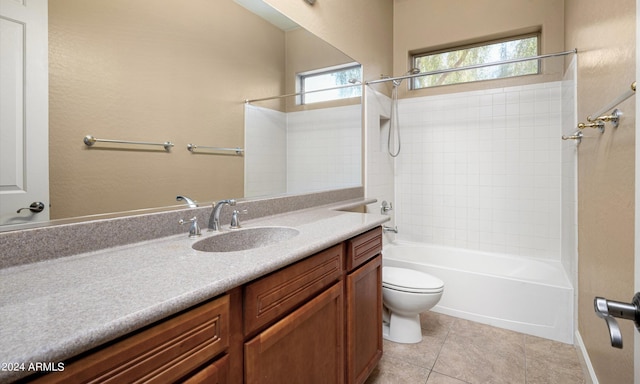 full bathroom featuring vanity, tiled shower / bath, tile patterned floors, and toilet