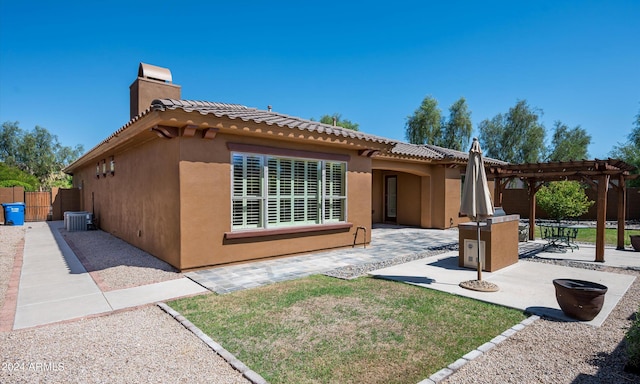 back of house with a pergola, a patio, and central air condition unit