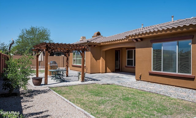 back of house featuring a yard, a pergola, and a patio area