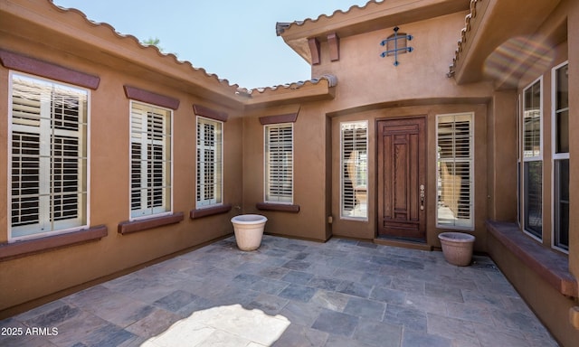 doorway to property with a patio