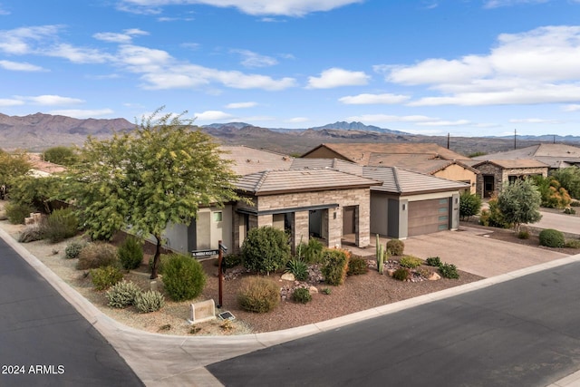 view of front of house featuring a mountain view and a garage