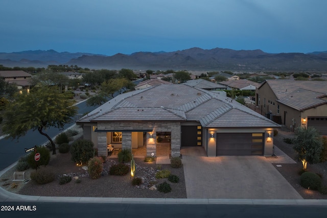 view of front of house featuring a mountain view and a garage