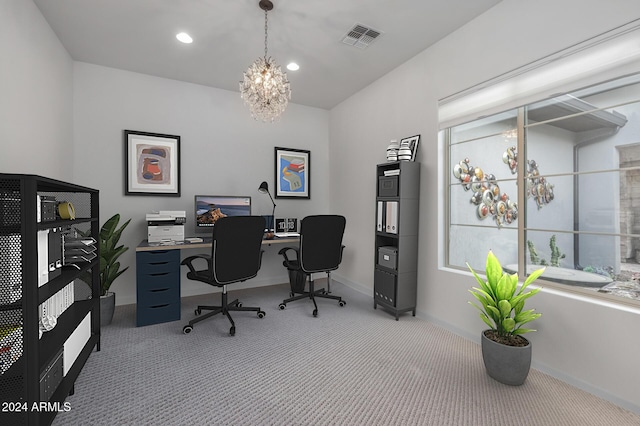 carpeted office with an inviting chandelier