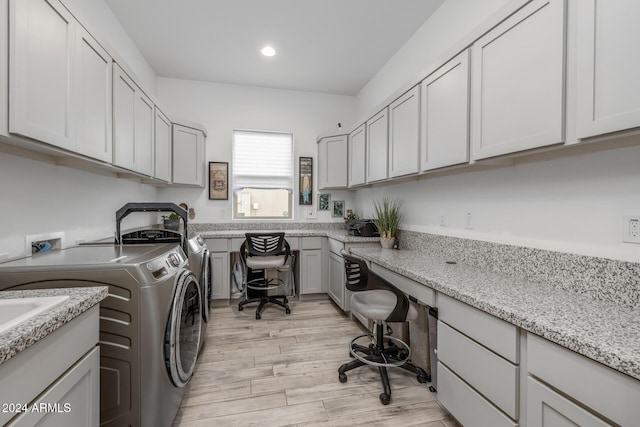 laundry area with cabinets, light hardwood / wood-style floors, and independent washer and dryer