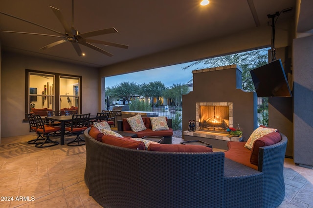 view of patio featuring an outdoor living space with a fireplace and ceiling fan