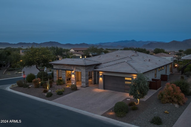 view of front facade featuring a mountain view and a garage