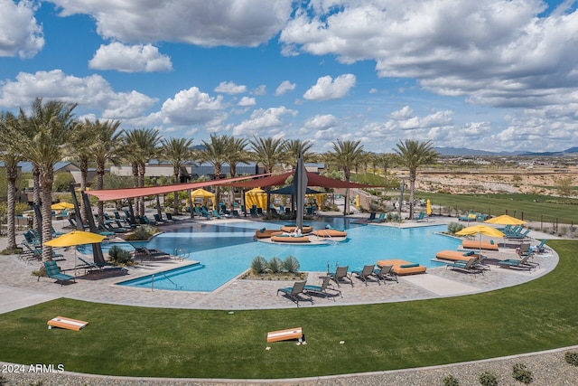 view of pool with a lawn and a patio area