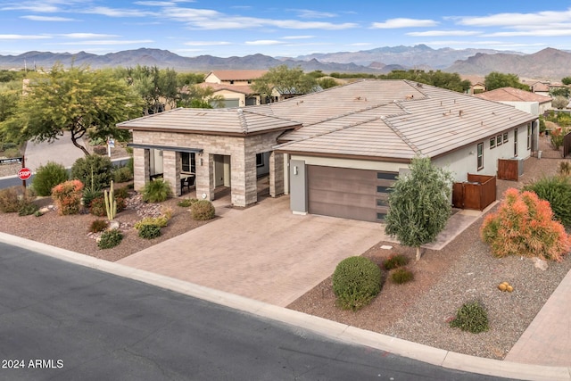 view of front of home with a mountain view and a garage