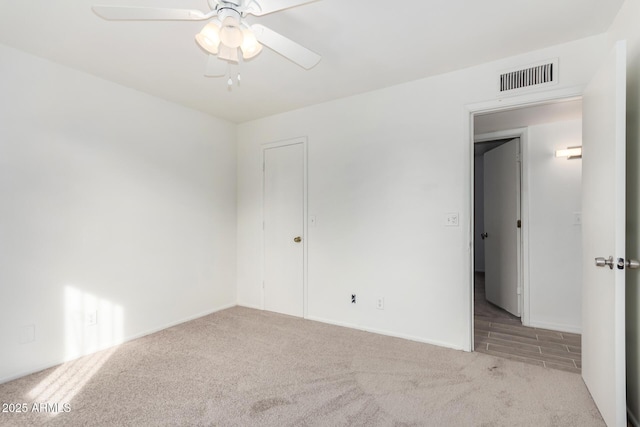 unfurnished room featuring ceiling fan and light carpet