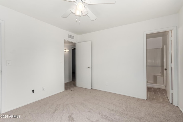 unfurnished bedroom featuring light carpet and ceiling fan