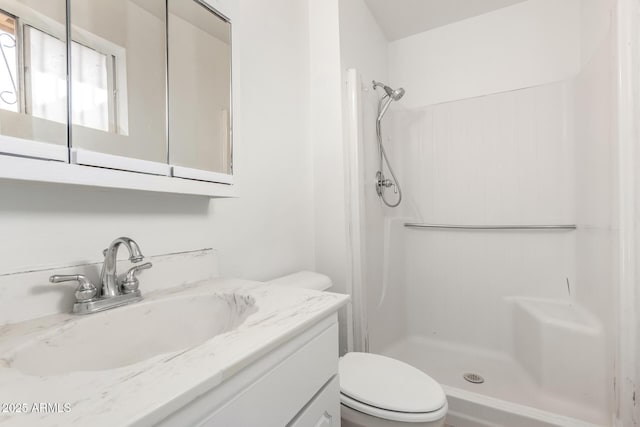 bathroom with vanity, toilet, and walk in shower