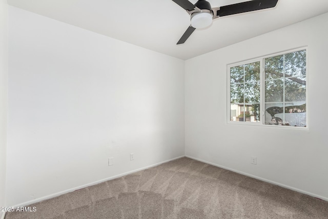 unfurnished room with ceiling fan and carpet flooring