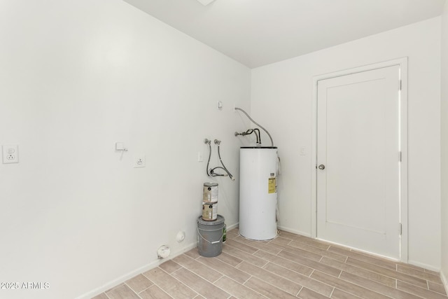 laundry room featuring water heater and light hardwood / wood-style flooring