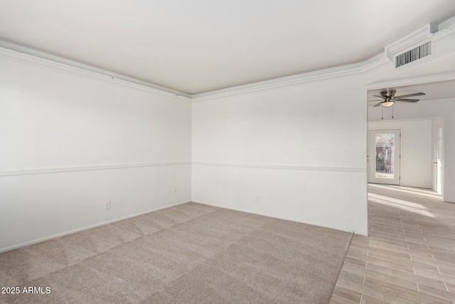 empty room with crown molding and ceiling fan