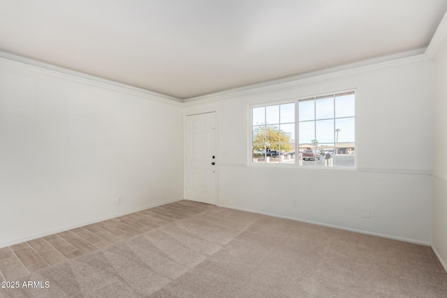 carpeted empty room featuring ornamental molding