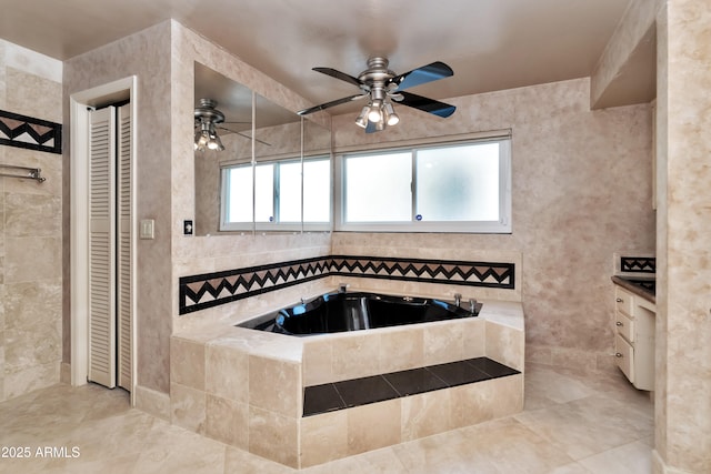 bathroom featuring a closet, ceiling fan, vanity, and a bath