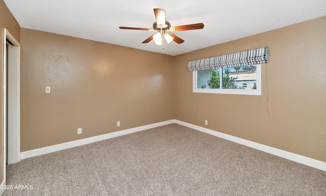 unfurnished room with carpet, baseboards, and a ceiling fan