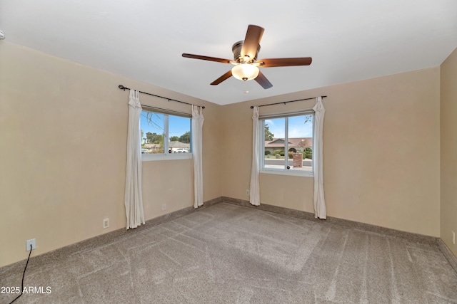 unfurnished room featuring carpet, baseboards, and a ceiling fan