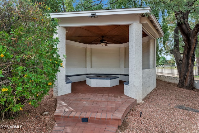 view of patio with ceiling fan and fence