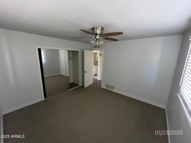 unfurnished bedroom featuring carpet floors, ceiling fan, and a closet