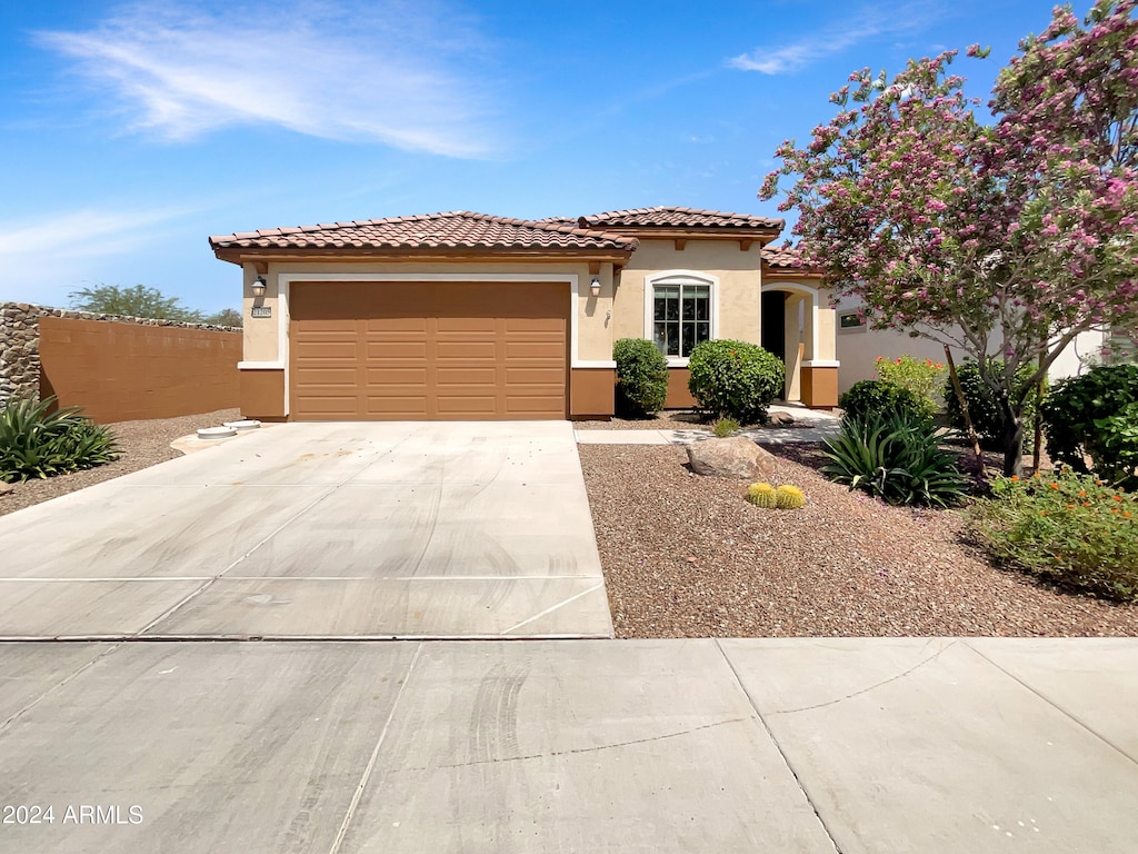 mediterranean / spanish house with a garage