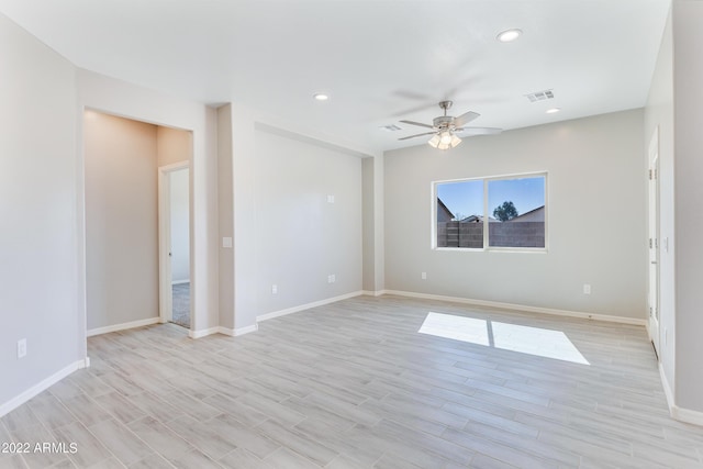 spare room featuring light hardwood / wood-style floors and ceiling fan