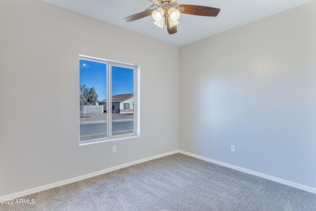 unfurnished room featuring ceiling fan and carpet floors