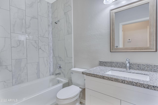 full bathroom with vanity, tiled shower / bath, and toilet