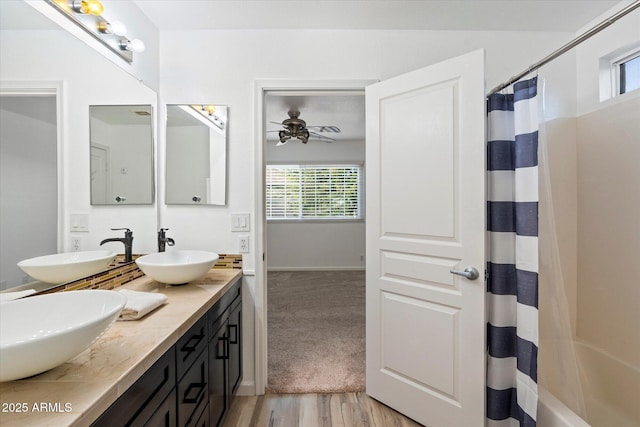 bathroom with vanity, a healthy amount of sunlight, hardwood / wood-style floors, and ceiling fan