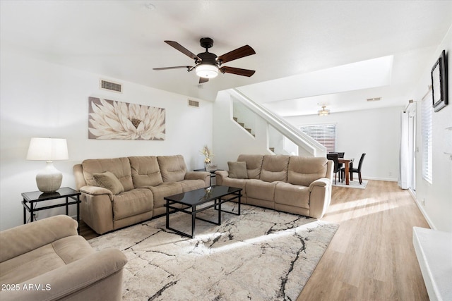 living room featuring ceiling fan and light wood-type flooring