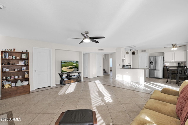 living room featuring ceiling fan and light tile patterned floors