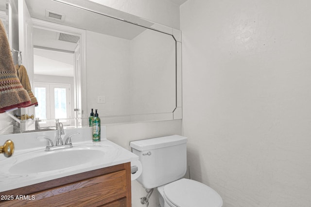 bathroom with toilet and vanity