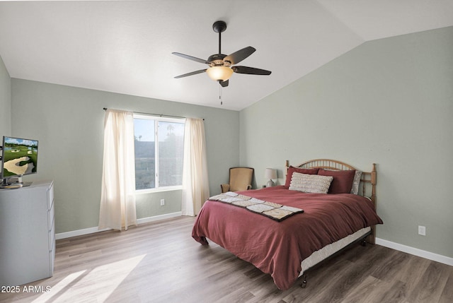 bedroom featuring ceiling fan, vaulted ceiling, and hardwood / wood-style flooring