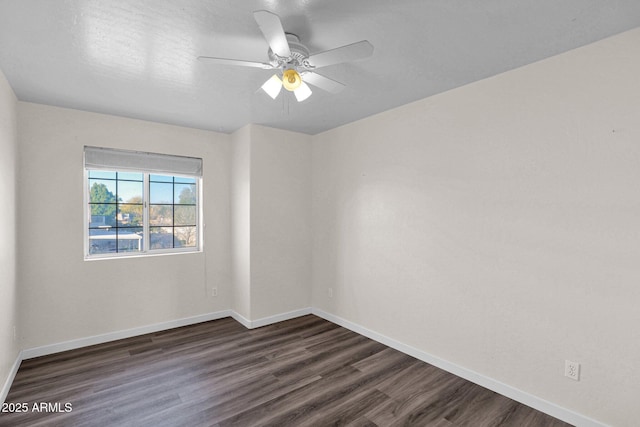 spare room featuring ceiling fan and dark hardwood / wood-style flooring