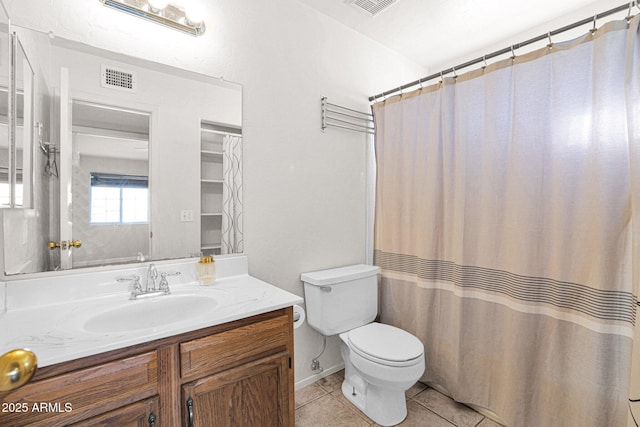 bathroom with toilet, vanity, tile patterned flooring, and a shower with shower curtain