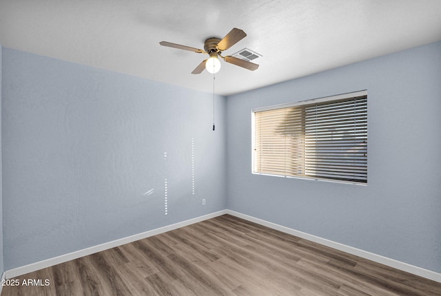 empty room featuring ceiling fan and hardwood / wood-style flooring