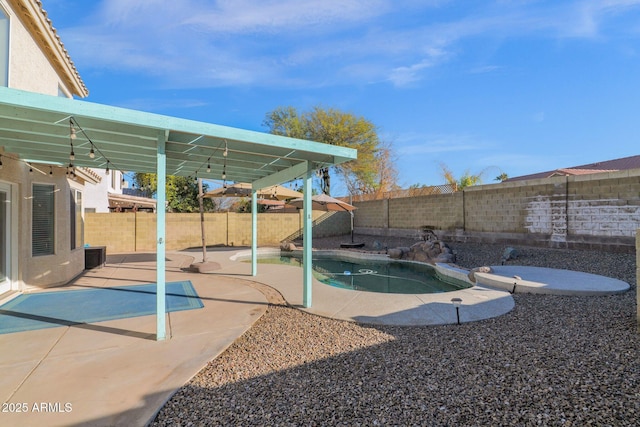 view of pool featuring central AC unit and a patio