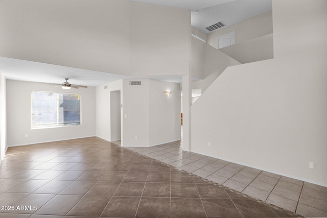 tiled spare room with ceiling fan