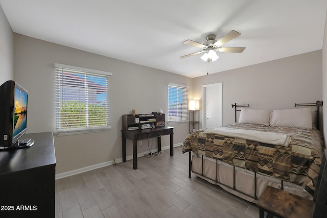 bedroom featuring wood finished floors, baseboards, and ceiling fan