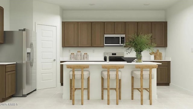 5064 S 234th Ave, Buckeye, AZ 85326 - kitchen with stainless steel appliances, light countertops, a center island, and light tile patterned flooring