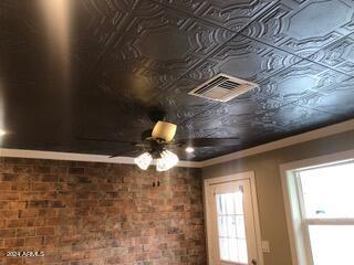 room details featuring ceiling fan and ornamental molding